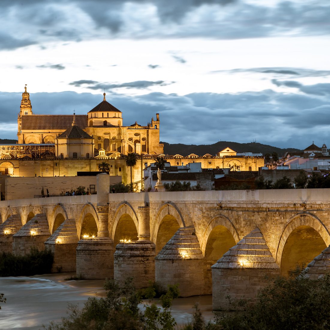 Ancient roman bridge over the river in Cordoba and the fortress.