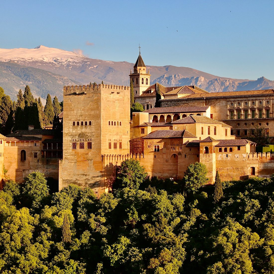 Generalife old construction surrounded by the evergreen gardens in the Alhambra tour.