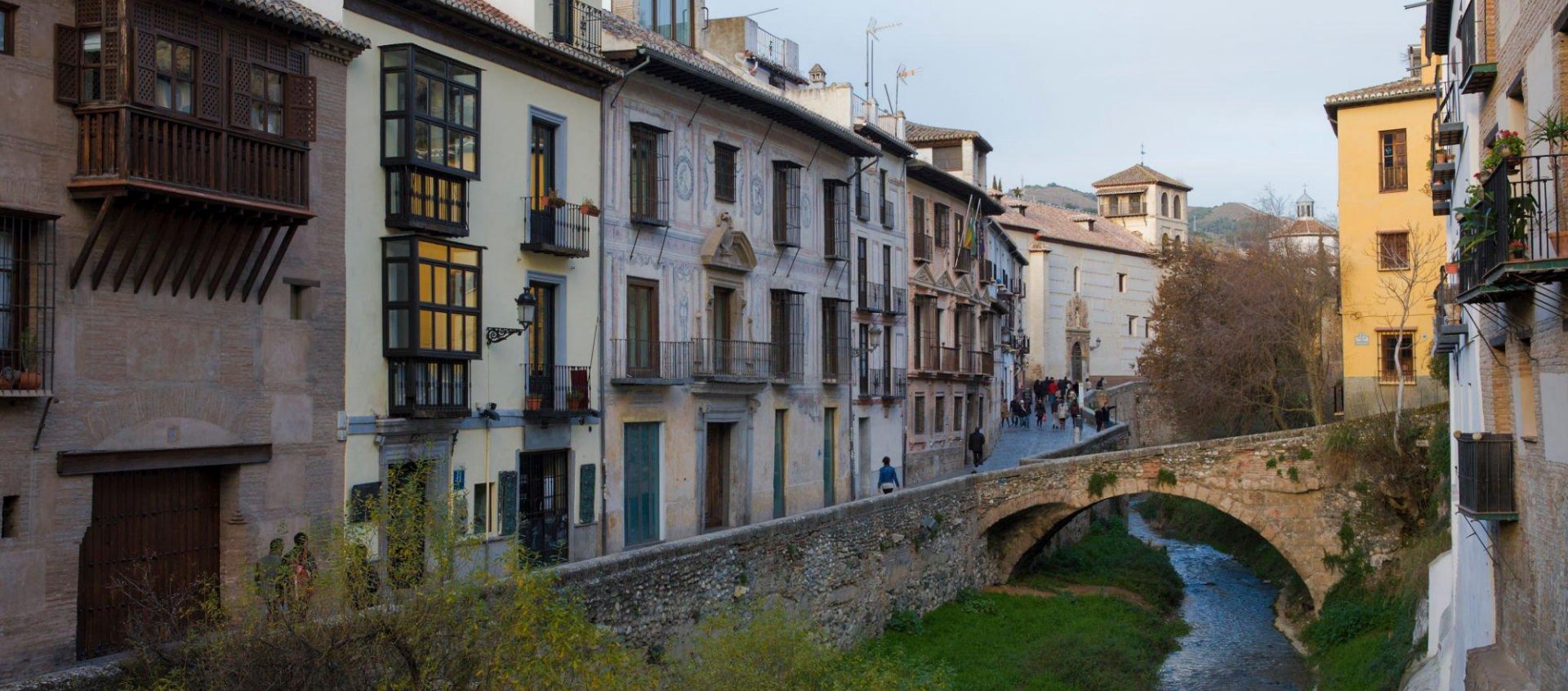 Street of the district of Albaicyn with its typical houses and the creek that crosses it.